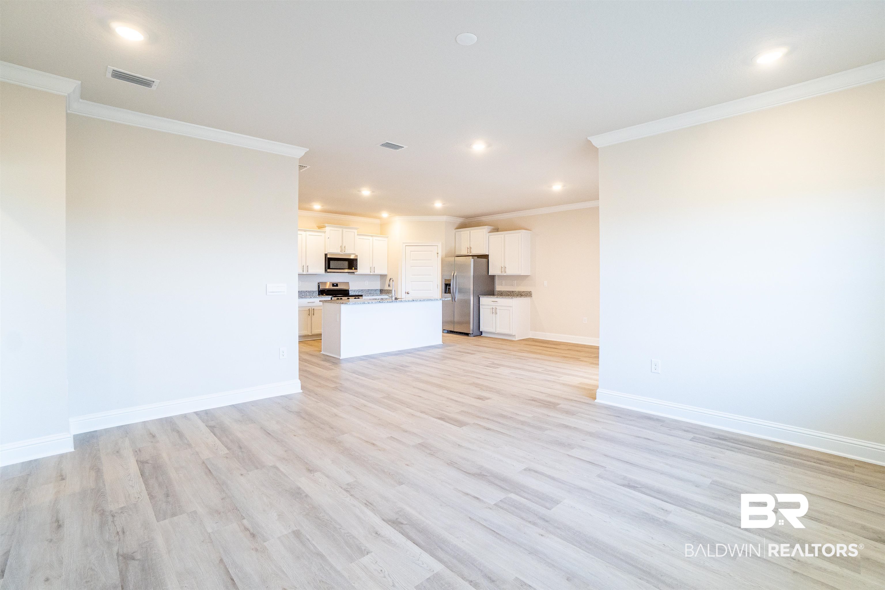 1073 Hayward Loop Foley, AL 36535 - Photo 15 of 18 Bright interior space featuring light wood-finish flooring, recessed lighting, and crown molding