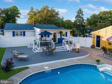 an aerial view of residential house with outdoor space and swimming pool