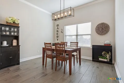 a kitchen with kitchen island granite countertop a sink a counter space stainless steel appliances and cabinets
