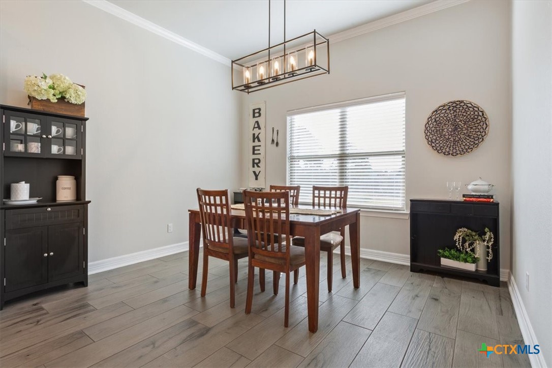 102 Rancho Del Lago Lane Belton, TX 76513 - Photo 11 of 40 a view of a dining room with furniture and window