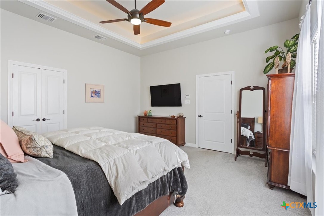 102 Rancho Del Lago Lane Belton, TX 76513 - Photo 17 of 40 a bedroom with a bed and a flat tv screen on dresser