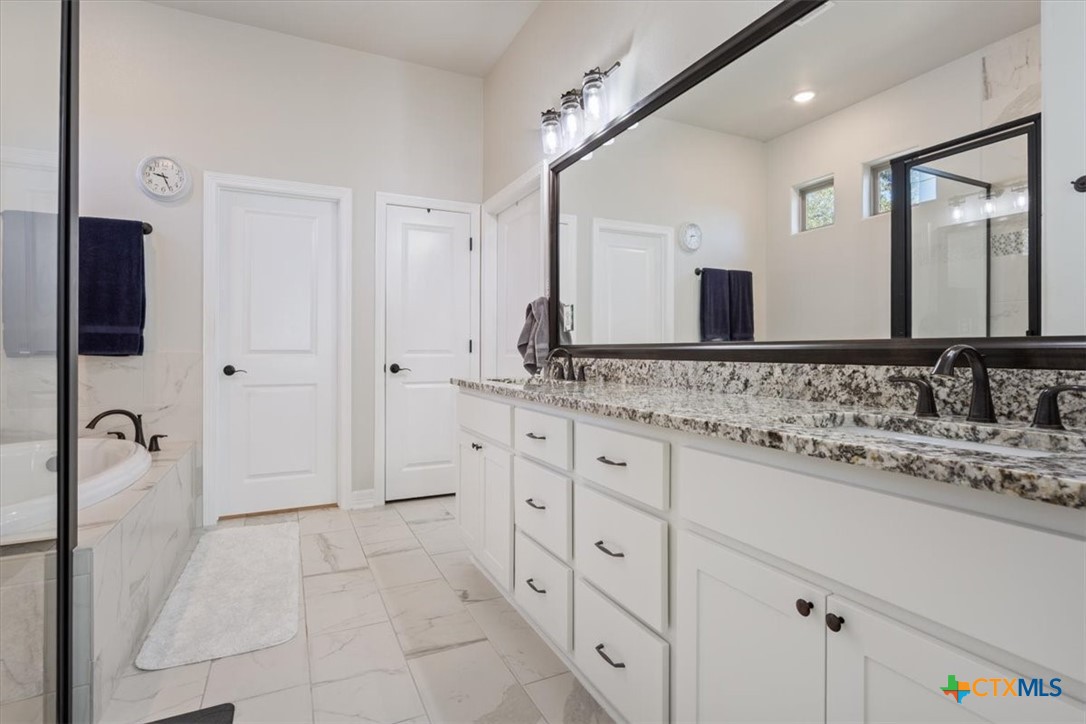 102 Rancho Del Lago Lane Belton, TX 76513 - Photo 19 of 40 a bathroom with a granite countertop sink and a mirror