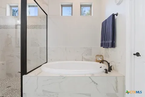 a bathroom with a bathtub and a shower