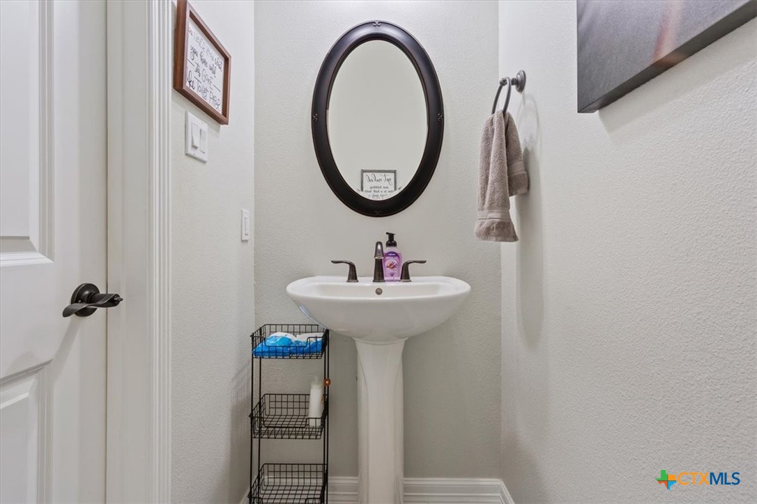 102 Rancho Del Lago Lane Belton, TX 76513 - Photo 25 of 40 a bathroom with a sink and a mirror