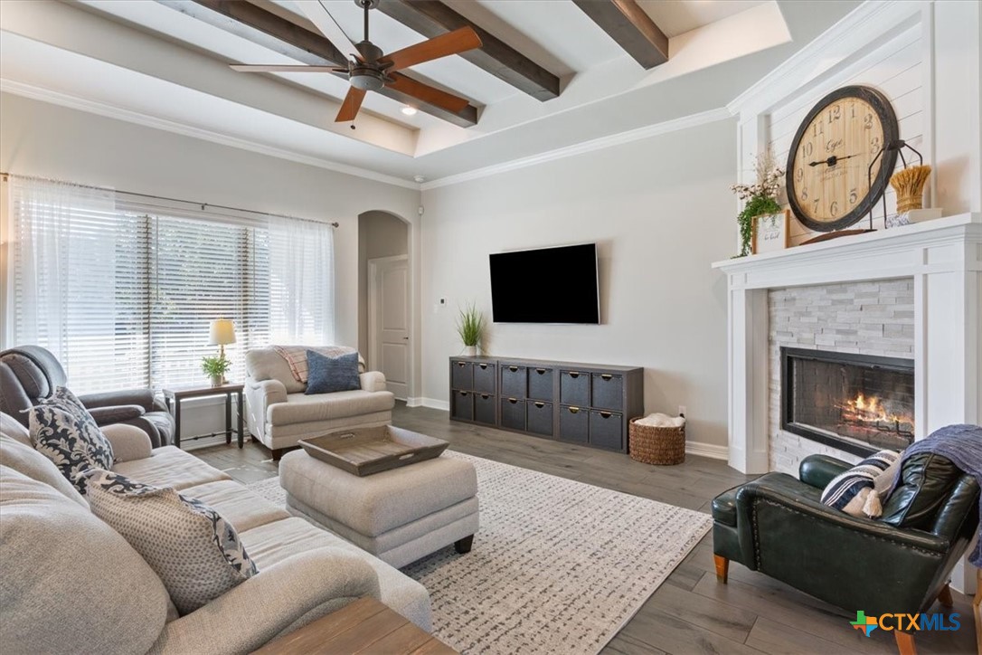 102 Rancho Del Lago Lane Belton, TX 76513 - Photo 7 of 40 a living room with furniture a flat screen tv and a fireplace
