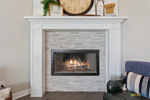 a living room with furniture a clock and a fireplace