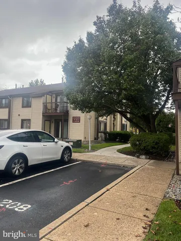 a car parked in front of a white house