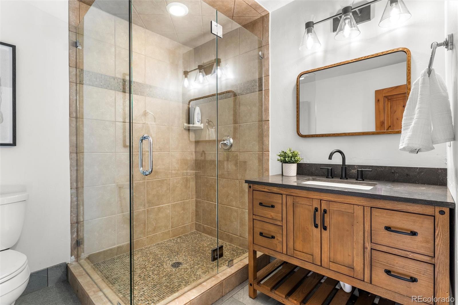 214 Wellington Road Breckenridge, CO 80424 - Photo 35 of 48 a bathroom with a bathtub shower sink mirror and toilet