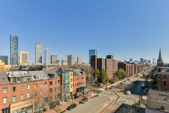 a kitchen with stainless steel appliances granite countertop a sink a stove and a wooden floors
