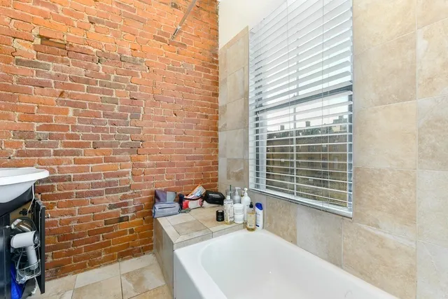 a view of a balcony with wooden floor and fence