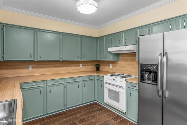 a kitchen with a sink cabinets and stainless steel appliances