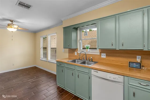 a kitchen with sink and mirror
