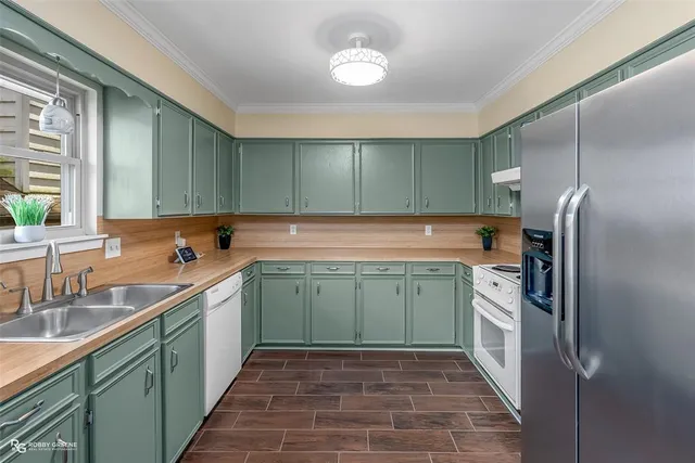 a kitchen with a refrigerator and a sink