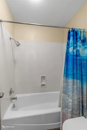 a bathroom with a bathtub and shower