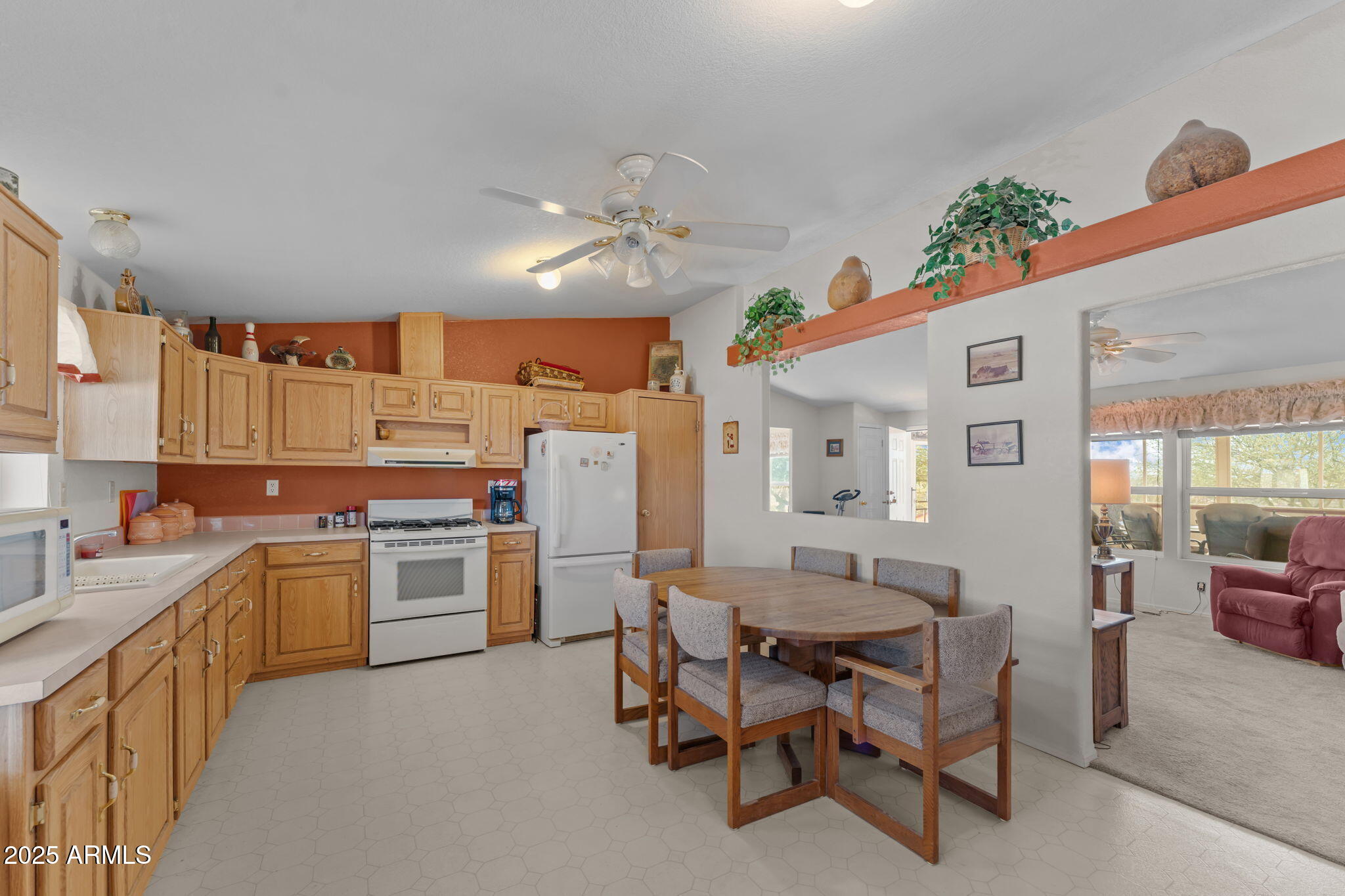 50910 West Long Rifle Road Aguila, AZ 85320 - Photo 13 of 59 a kitchen with a cabinets and chairs in it