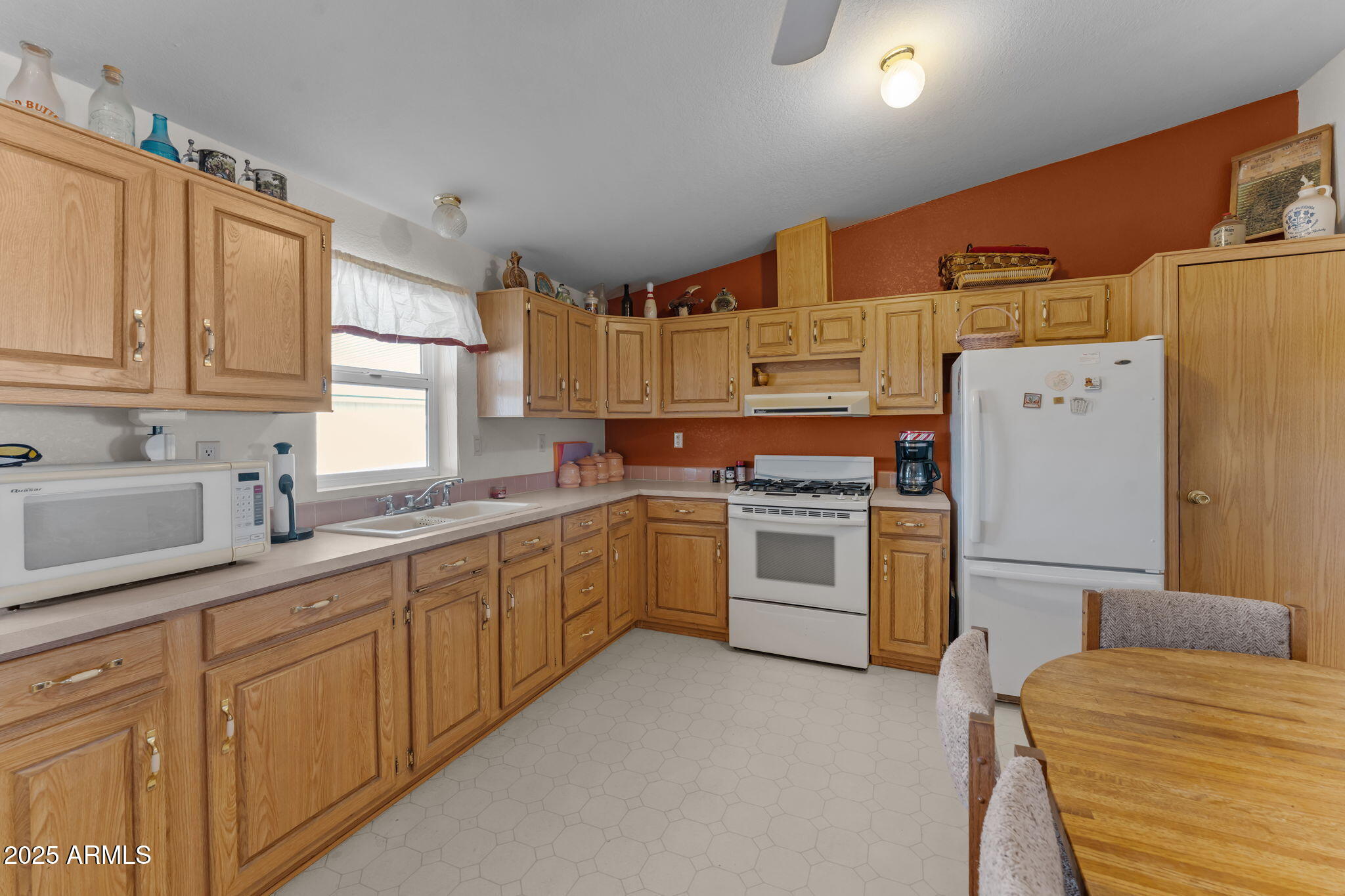 50910 West Long Rifle Road Aguila, AZ 85320 - Photo 14 of 59 a kitchen with a white cabinets and white appliances