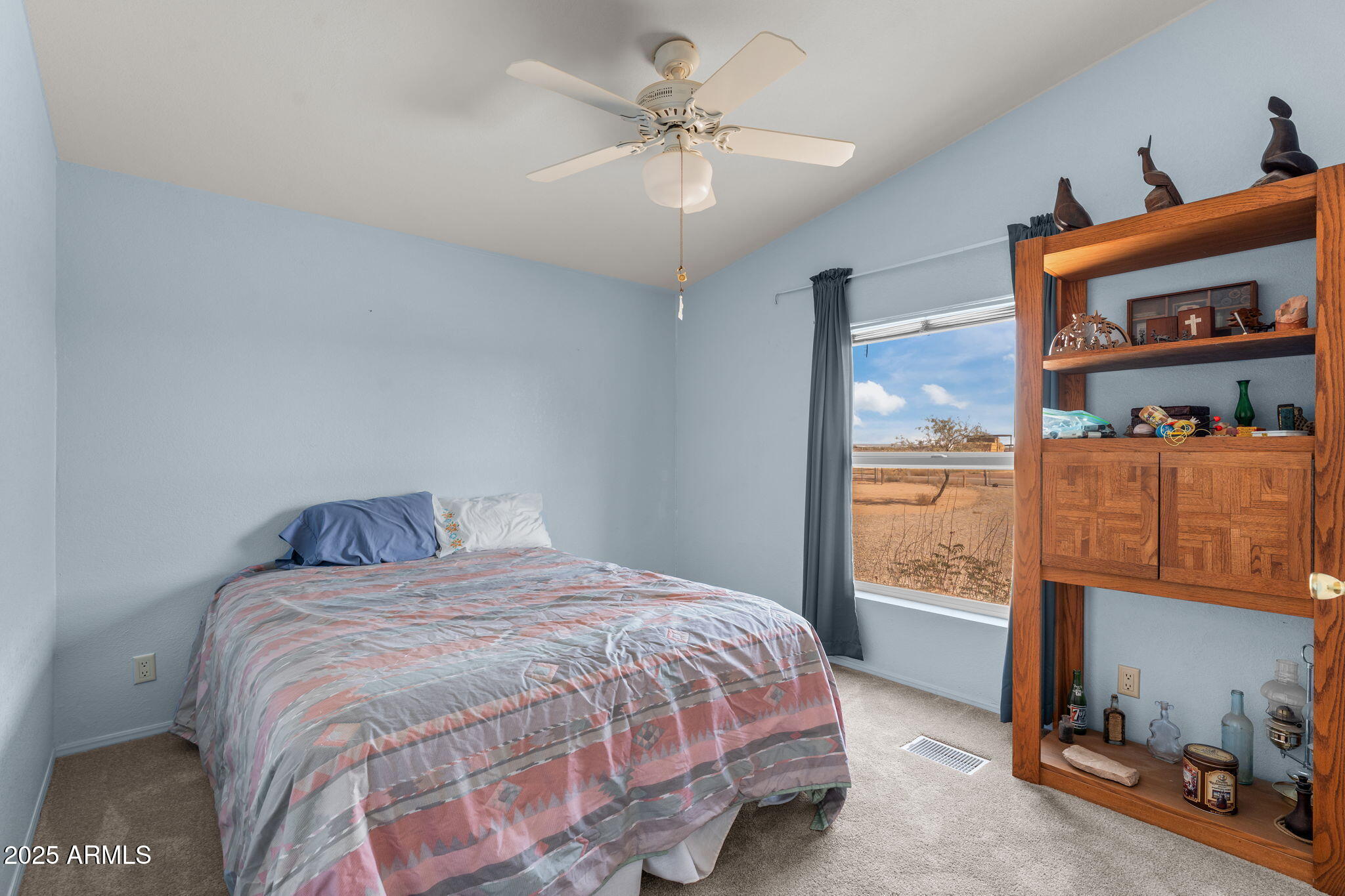 50910 West Long Rifle Road Aguila, AZ 85320 - Photo 19 of 59 a bedroom with a bed and a chandelier