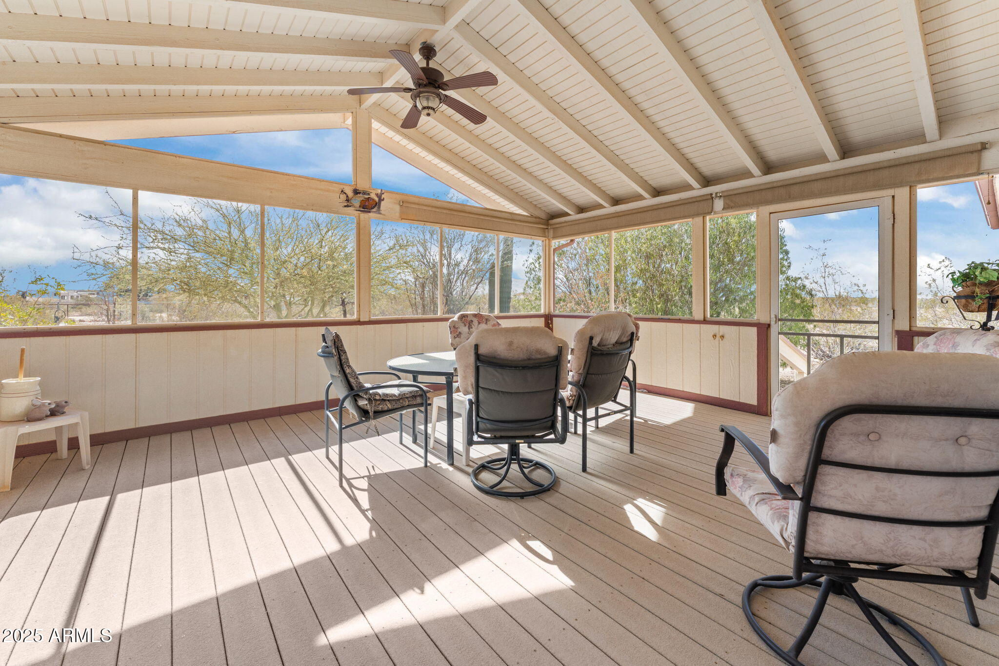 50910 West Long Rifle Road Aguila, AZ 85320 - Photo 22 of 59 a living room with furniture a wooden floor and a large window