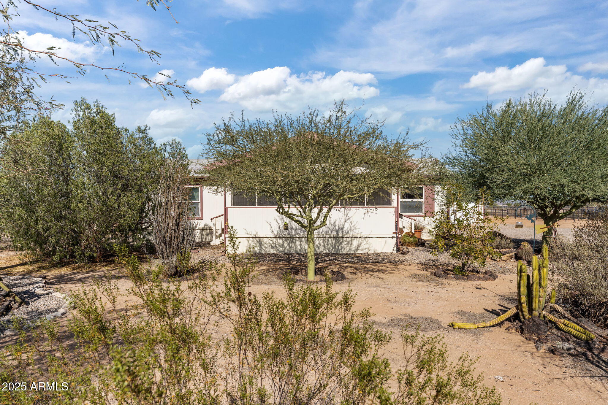 50910 West Long Rifle Road Aguila, AZ 85320 - Photo 29 of 59 a backyard of a house with table and chairs