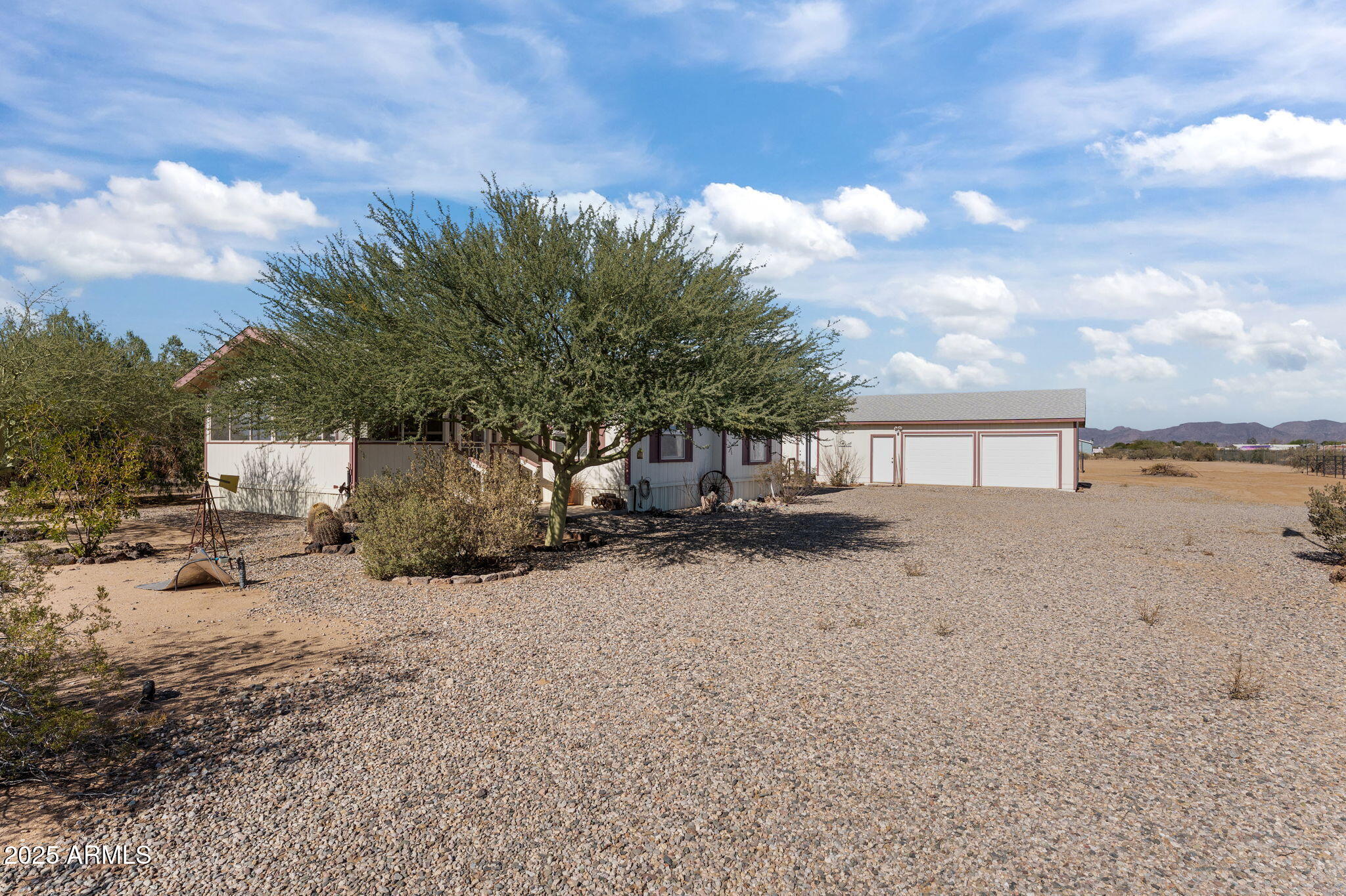 50910 West Long Rifle Road Aguila, AZ 85320 - Photo 30 of 59 a front view of a house with a yard