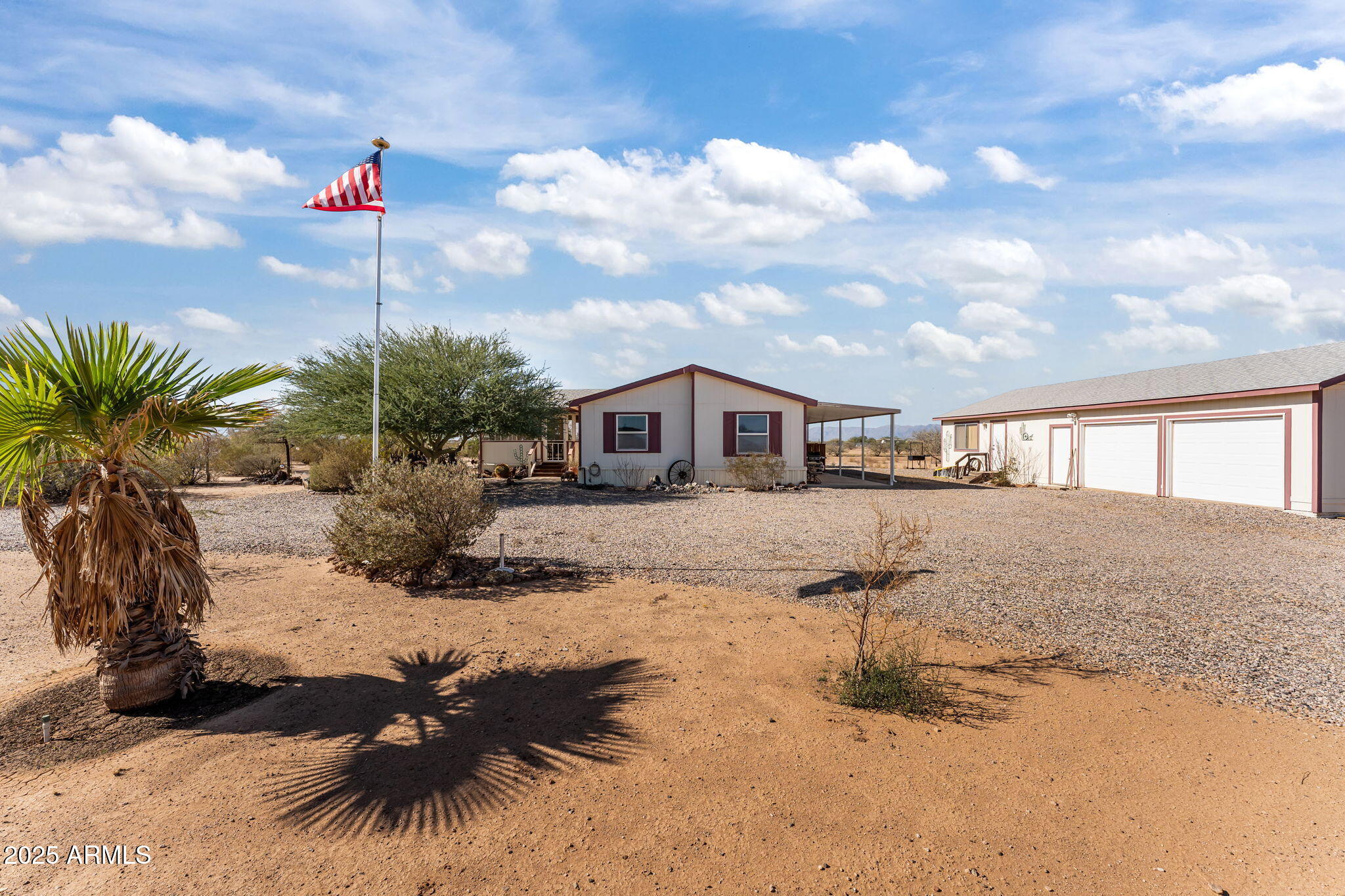 50910 West Long Rifle Road Aguila, AZ 85320 - Photo 6 of 59 a front view of a house with a yard and garage