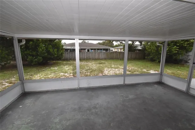 an empty room with sliding glass door