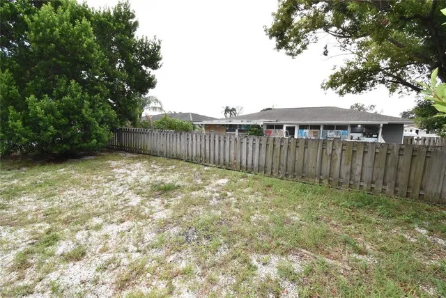 a view of a backyard with a tree