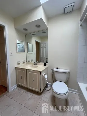 a bathroom with a toilet a sink and mirror
