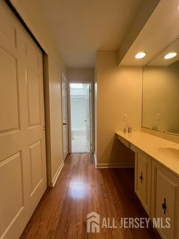 a view of hallway with wooden floor