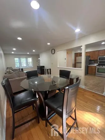 a large kitchen with a table and chairs