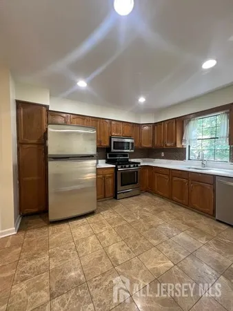 a kitchen with a refrigerator and a sink