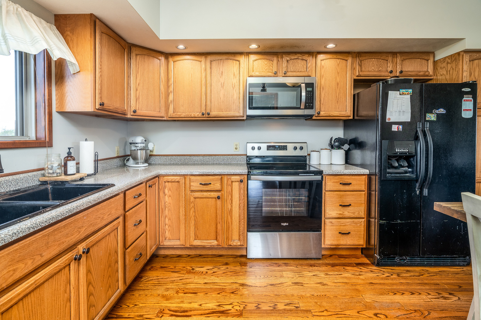 9242 East Park Street Road Du Quoin, IL 62832 - Photo 11 of 44 a kitchen with stainless steel appliances granite countertop a stove a sink and a microwave