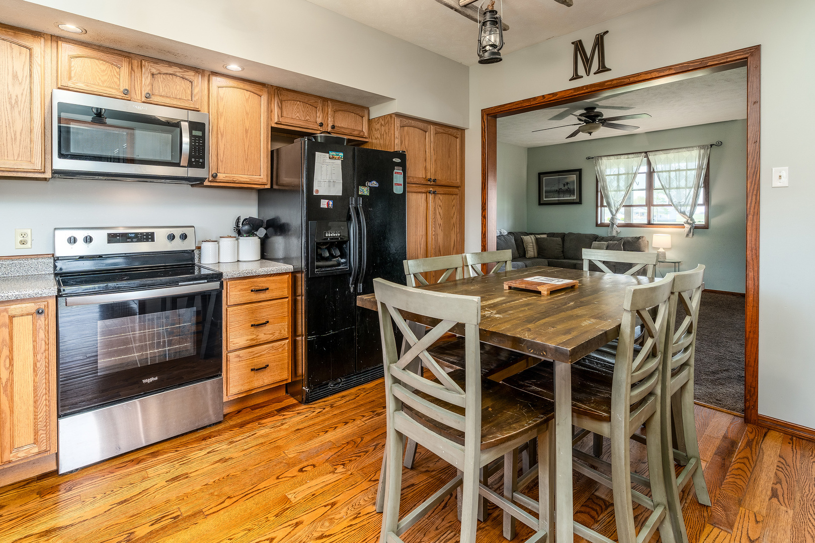9242 East Park Street Road Du Quoin, IL 62832 - Photo 13 of 44 a kitchen with stainless steel appliances kitchen island granite countertop a kitchen island hardwood floor and a sink