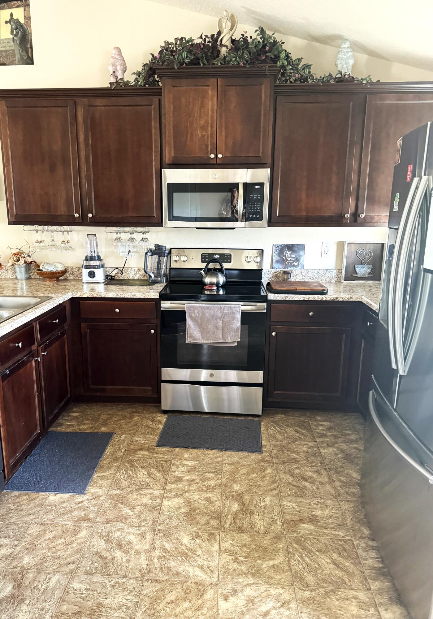 2177 Southeast Dolphin Road Port St. Lucie, FL 34952 - Photo 13 of 13 a kitchen with stainless steel appliances granite countertop a sink and stove top oven