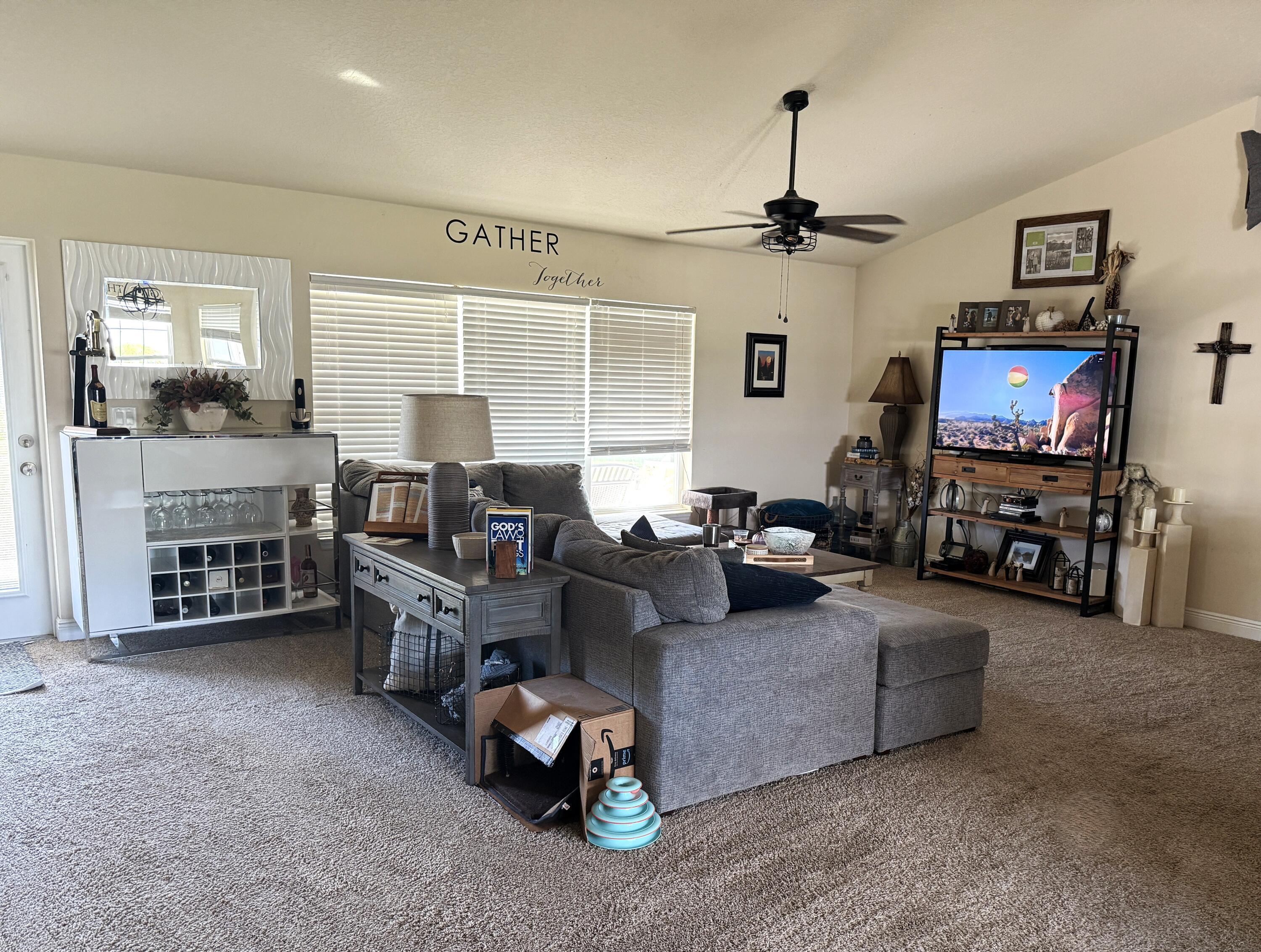 2177 Southeast Dolphin Road Port St. Lucie, FL 34952 - Photo 4 of 13 a living room with furniture and a flat screen tv