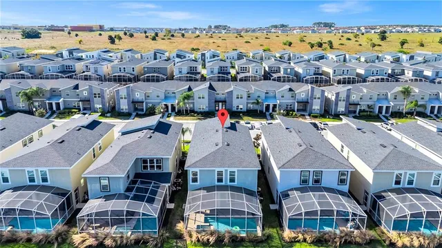 a front view of a house with a yard and lake view