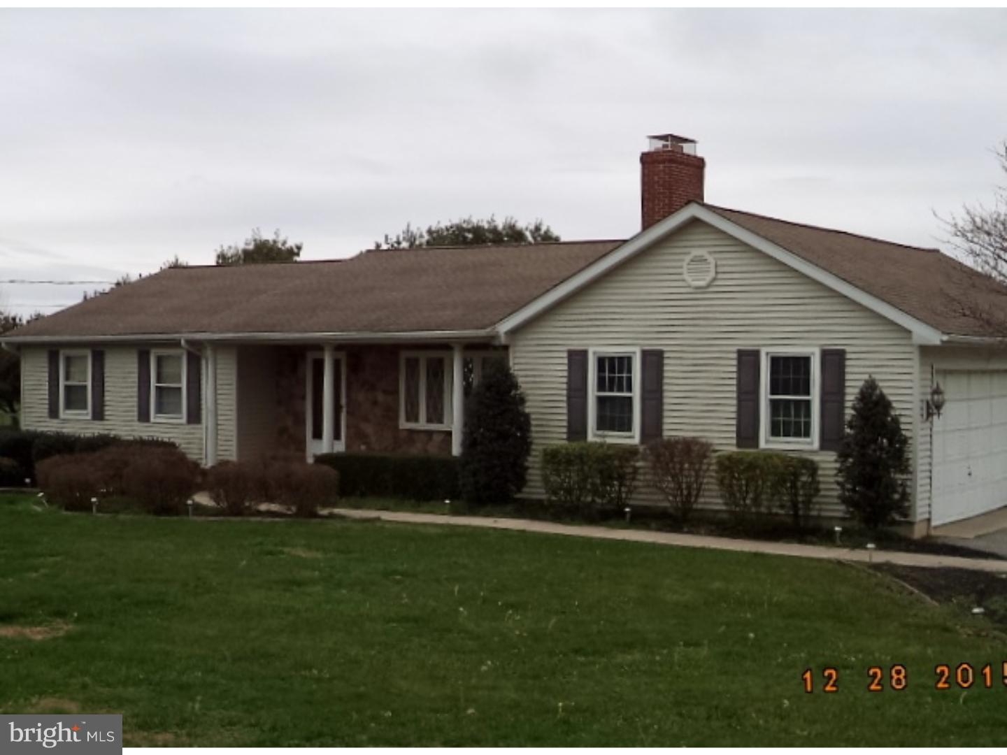 a front view of a house with a garden and yard