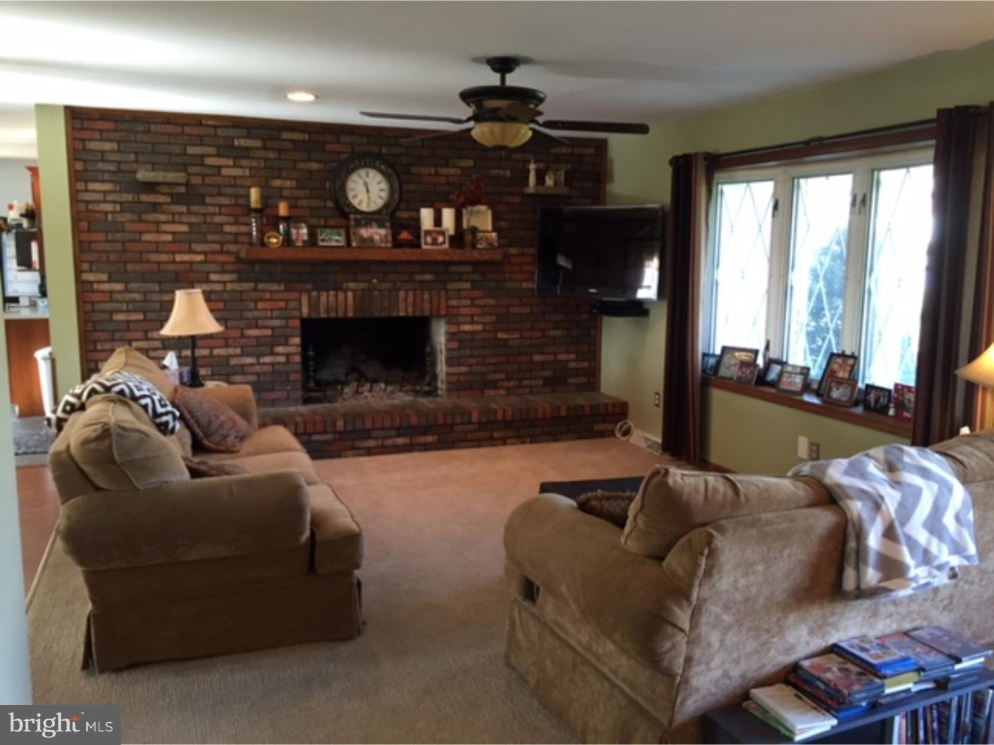 210 Shoemaker Road Bridgeton, NJ 08302 - Photo 12 of 22 a living room with furniture a fireplace and a large window