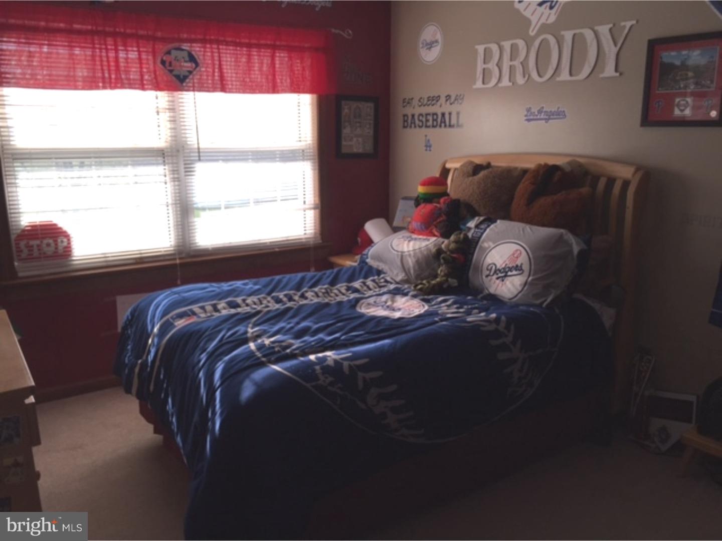 210 Shoemaker Road Bridgeton, NJ 08302 - Photo 16 of 22 a bed sitting in a bedroom next to a window
