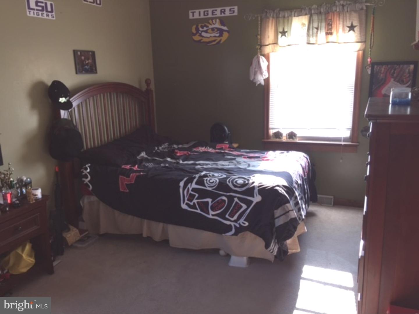 210 Shoemaker Road Bridgeton, NJ 08302 - Photo 17 of 22 a bed sitting in a bedroom next to a window