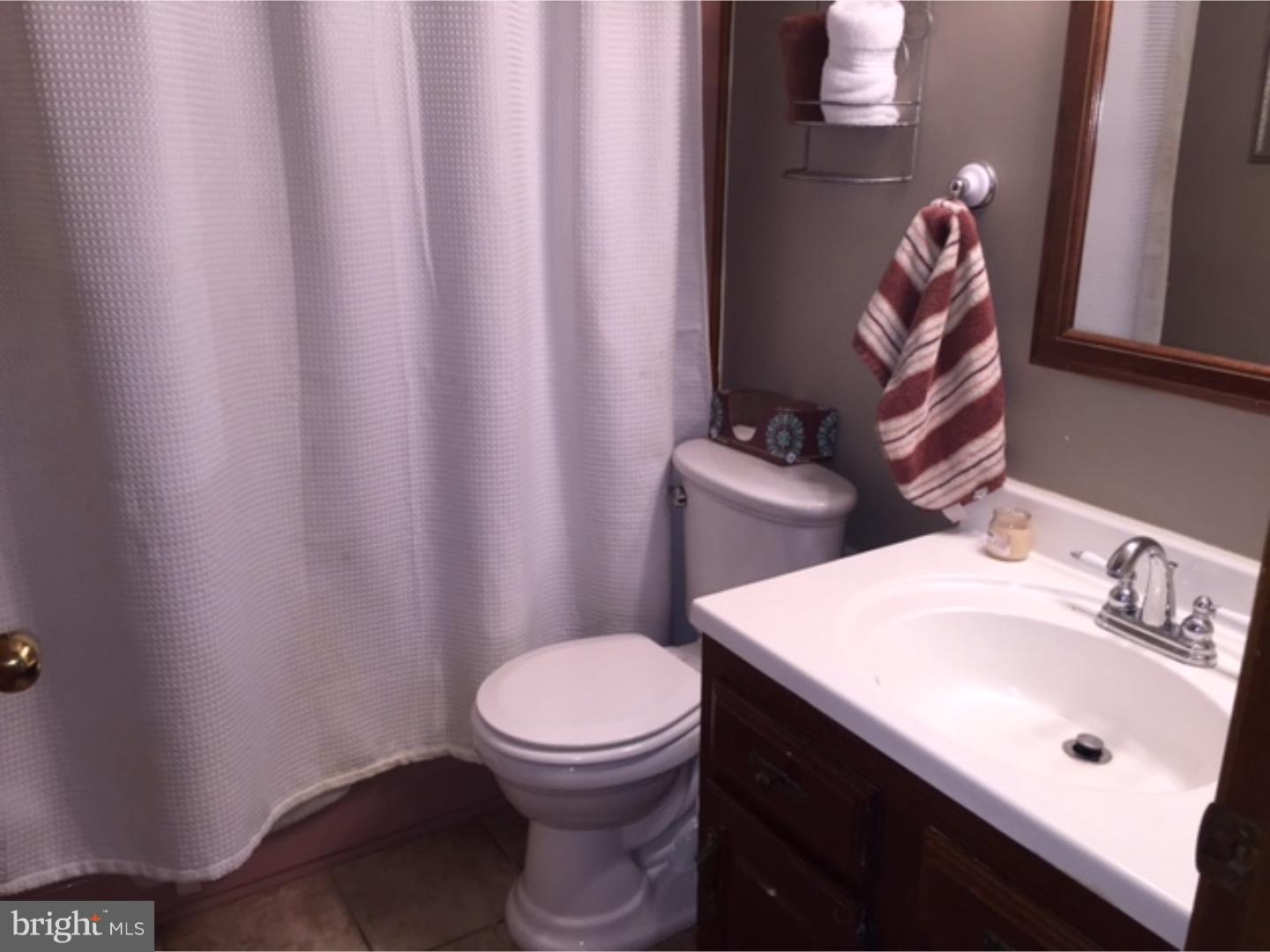 210 Shoemaker Road Bridgeton, NJ 08302 - Photo 18 of 22 a bathroom with a sink a toilet and a mirror