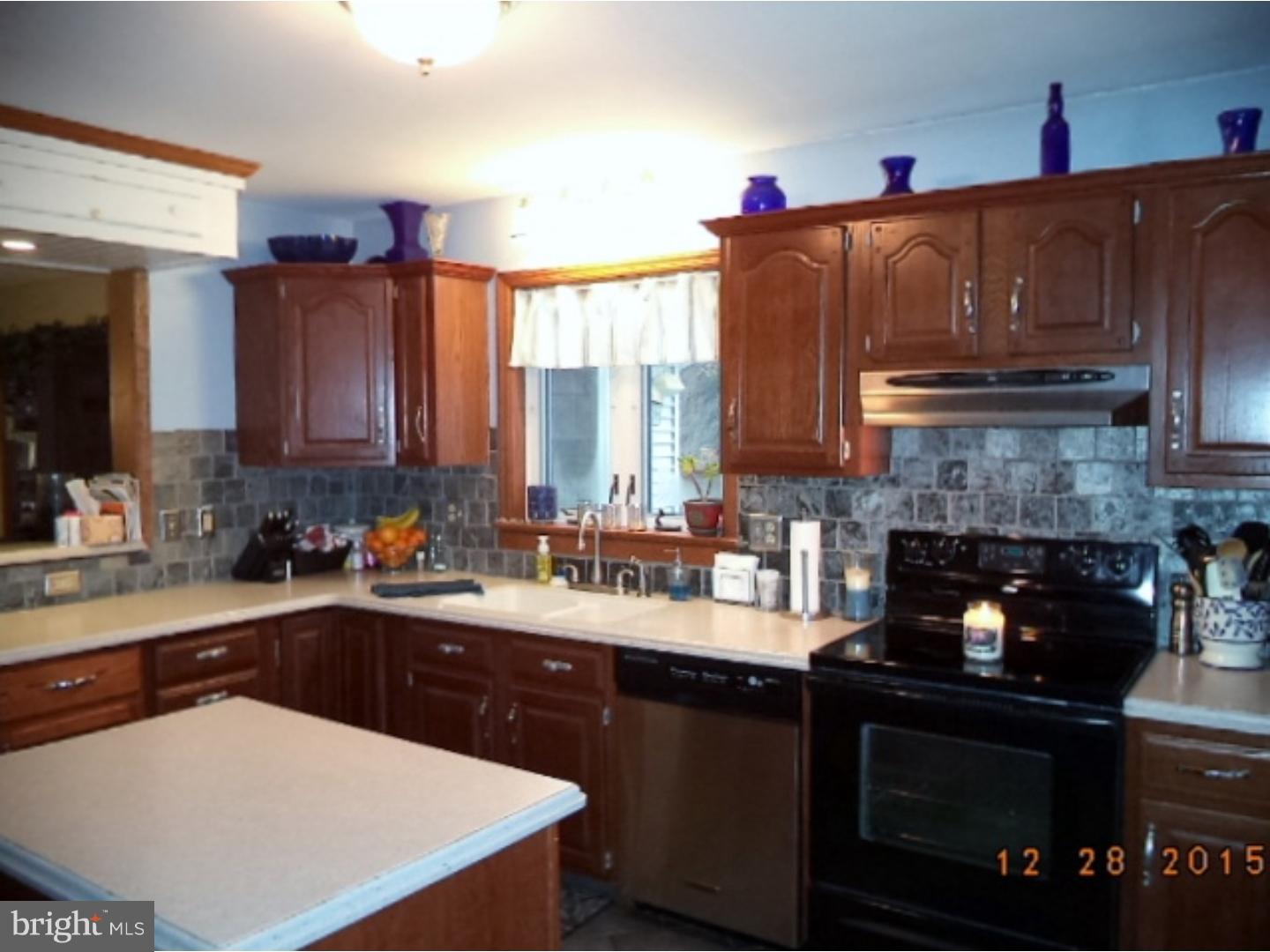 210 Shoemaker Road Bridgeton, NJ 08302 - Photo 6 of 22 a kitchen with a sink a stove and cabinets