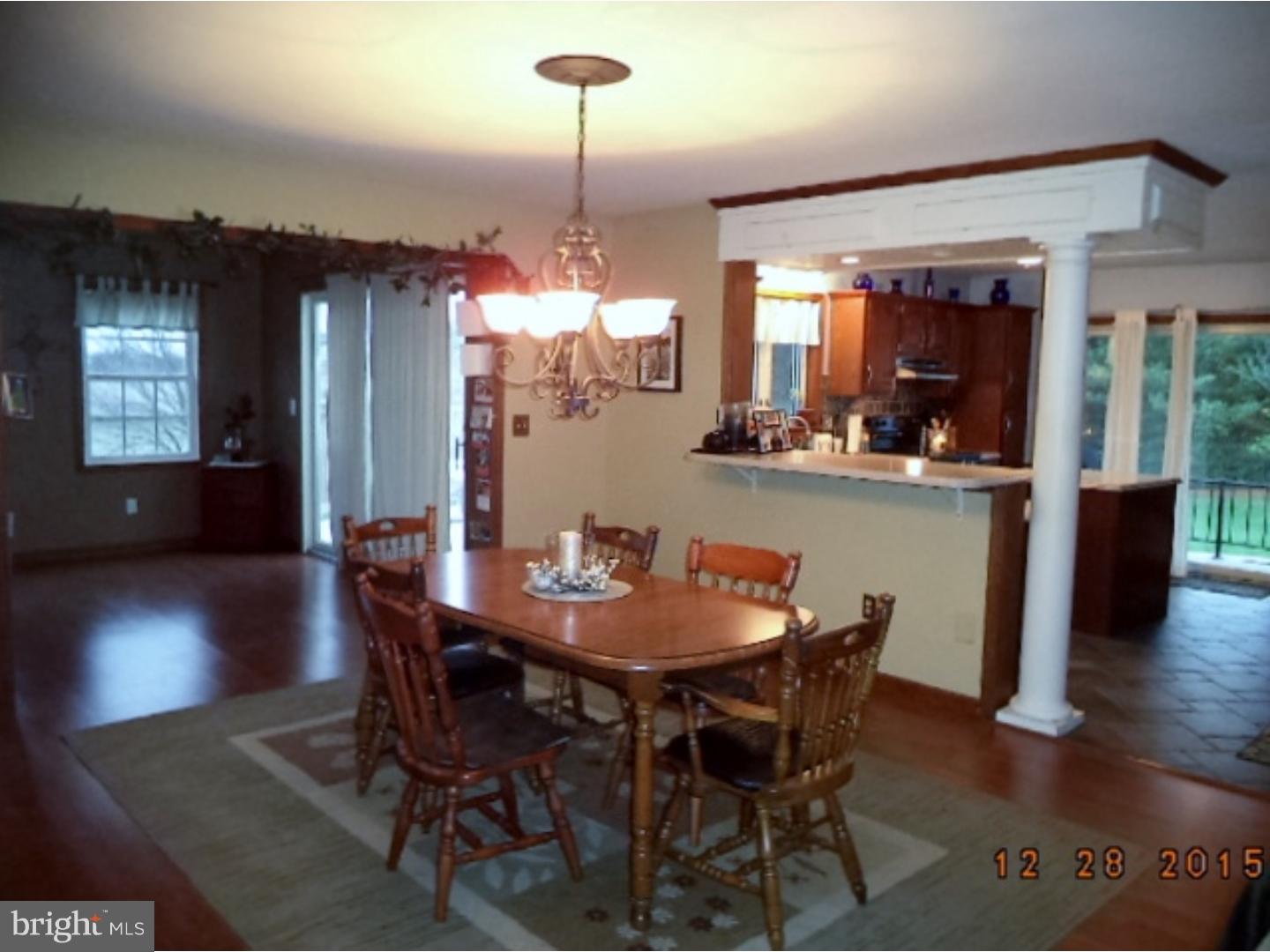 210 Shoemaker Road Bridgeton, NJ 08302 - Photo 8 of 22 a dining room with furniture wooden floor a rug and a chandelier