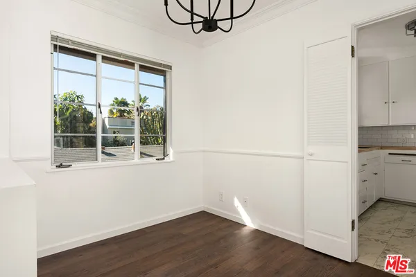 a view of a room with wooden floor and windows