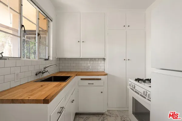 a kitchen with a sink and cabinets
