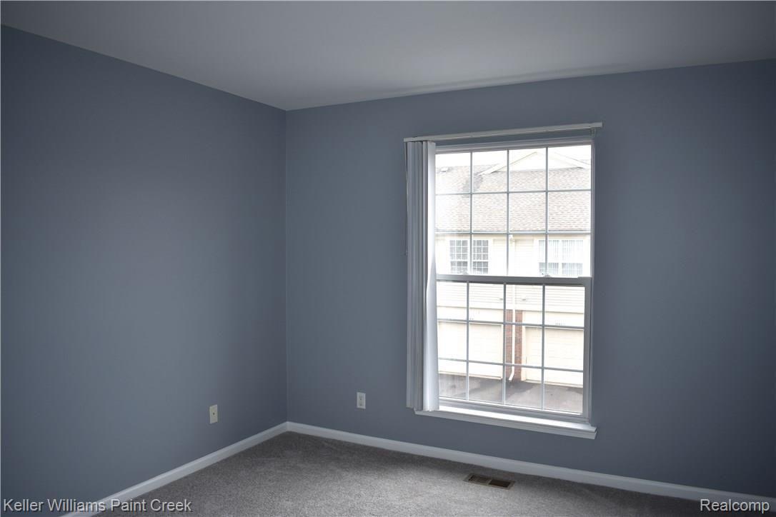1885 Flagstone Circle Rochester, MI 48307 - Photo 29 of 32 THERE IS A LARGE 2ND BEDROOM (11 X 12) WHICH CONTAINS A LARGE WINDOW THAT ALLOWS FOR NATURAL LIGHT TO ENTER THE BEDROOM. NOTE: THIS ROOM COULD ALSO BE USED FOR AN OFFICE OR AS A FAMILY ROOM