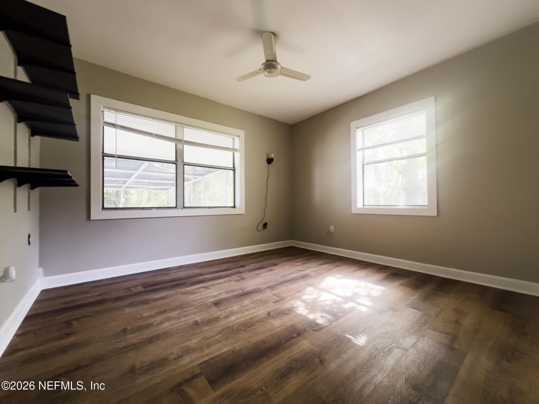 2085 Mills Road Jacksonville, FL 32216 - Photo 4 of 13 an empty room with wooden floor and windows