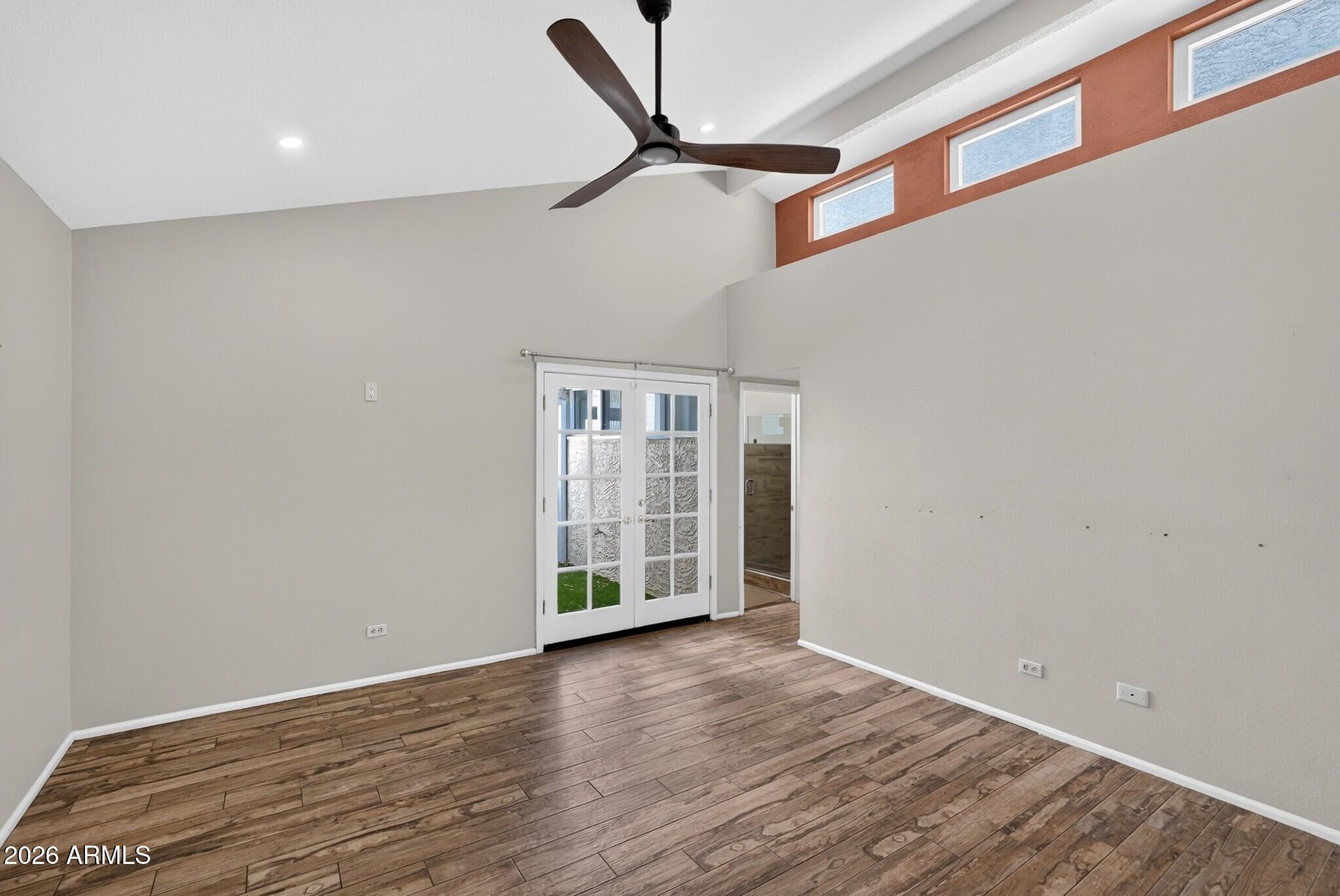 4615 East Monte Way Phoenix, AZ 85044 - Photo 22 of 35 a view of an empty room with wooden floor and a ceiling fan