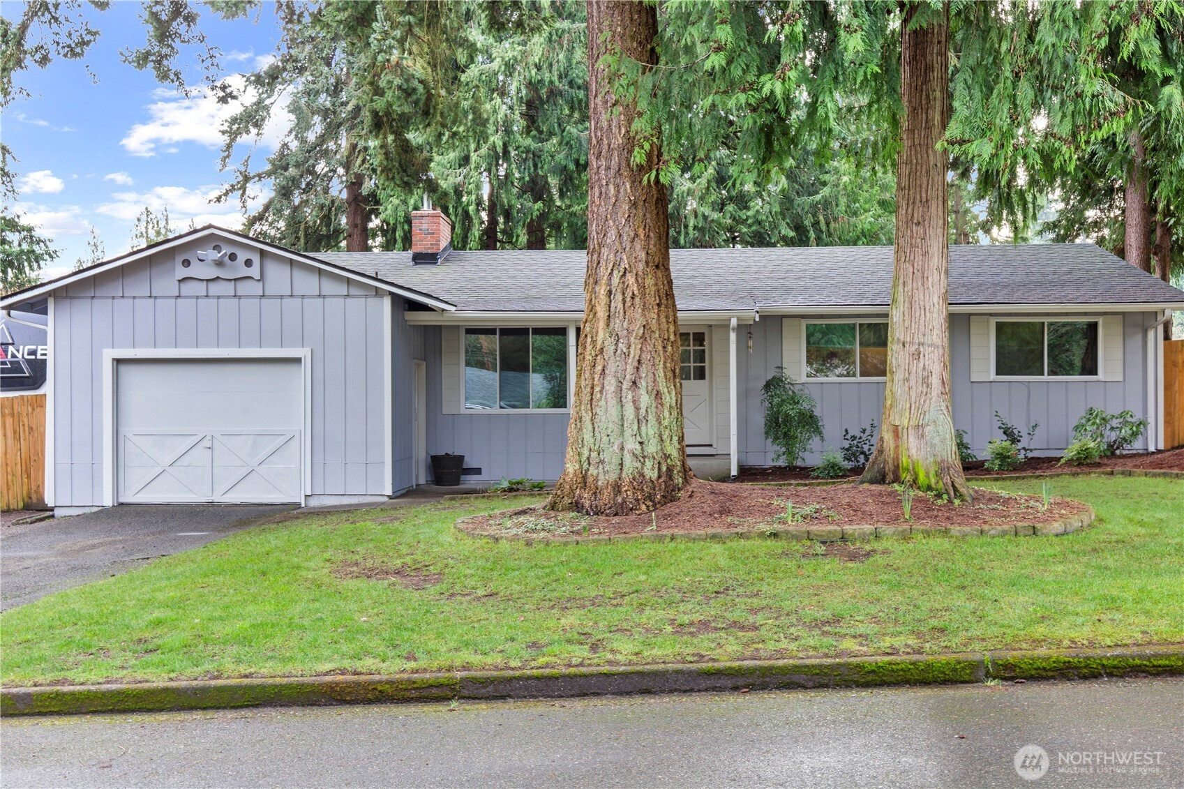 203 South 357th Street Federal Way, WA 98003 - Photo 2 of 28 a front view of a house with a yard and garage