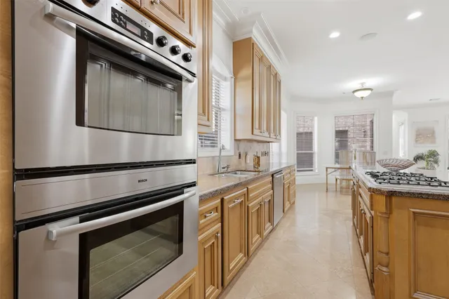 a kitchen with stainless steel appliances a stove and a microwave